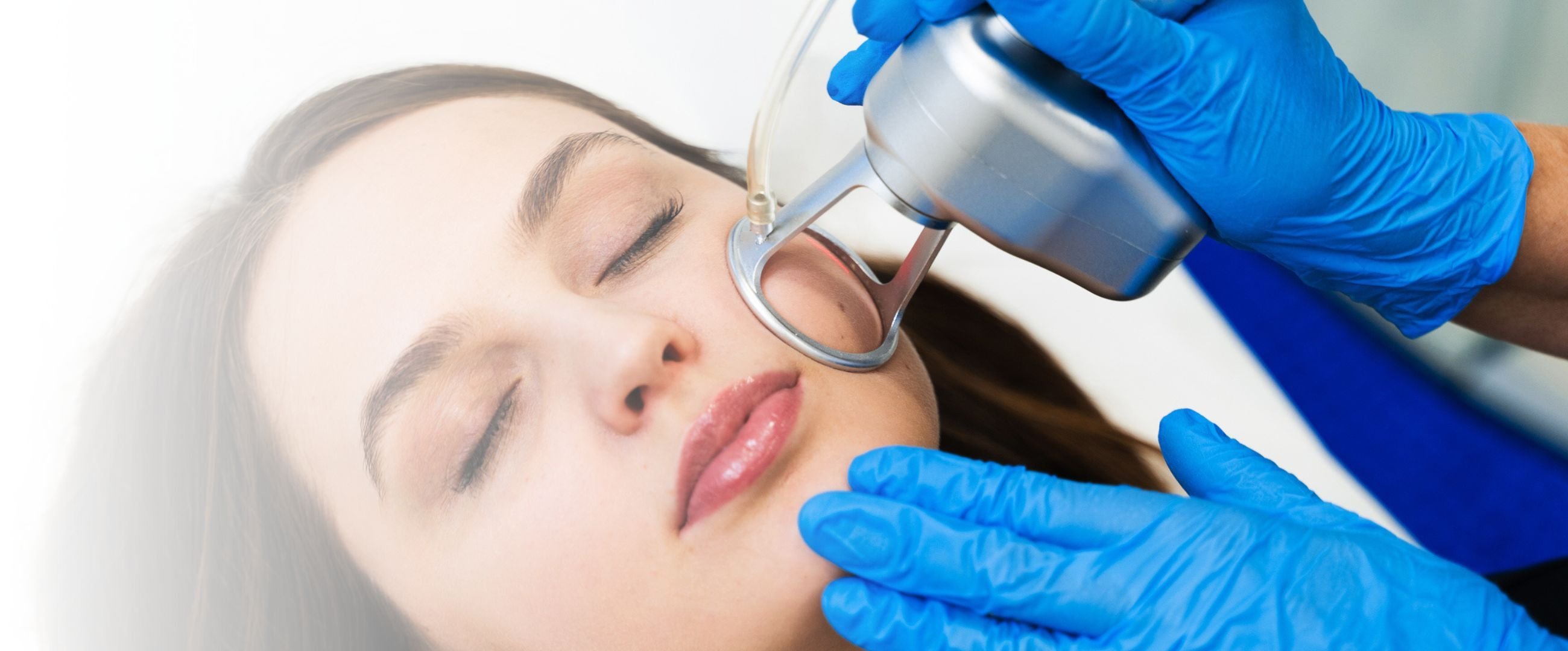 woman receiving laser treatment on face